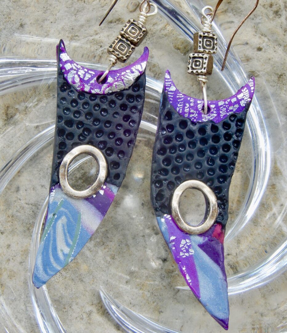 Black, blue, and violet triangular earrings
